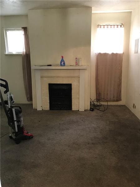 unfurnished living room featuring dark colored carpet