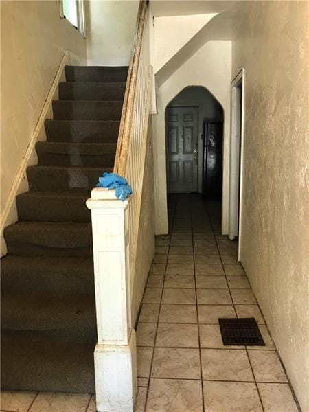 stairs featuring light tile floors