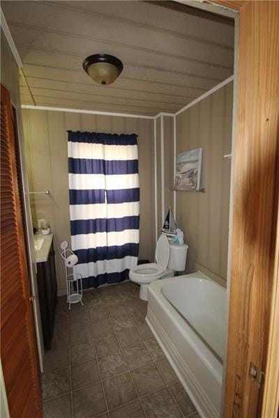 bathroom featuring tile floors, shower / bath combo, and toilet