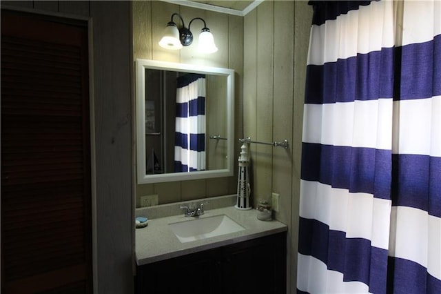 bathroom featuring ornamental molding and vanity