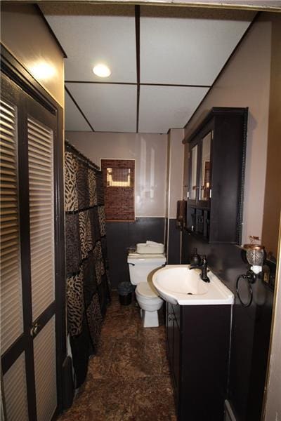 bathroom featuring vanity, toilet, and tile floors