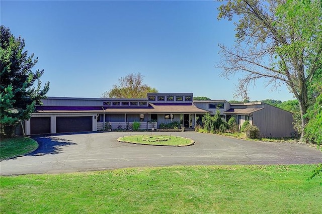 view of front of property with a front yard and a garage