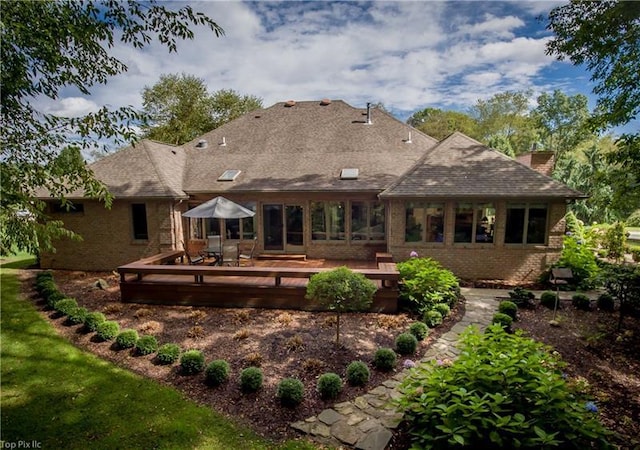 rear view of house with a wooden deck