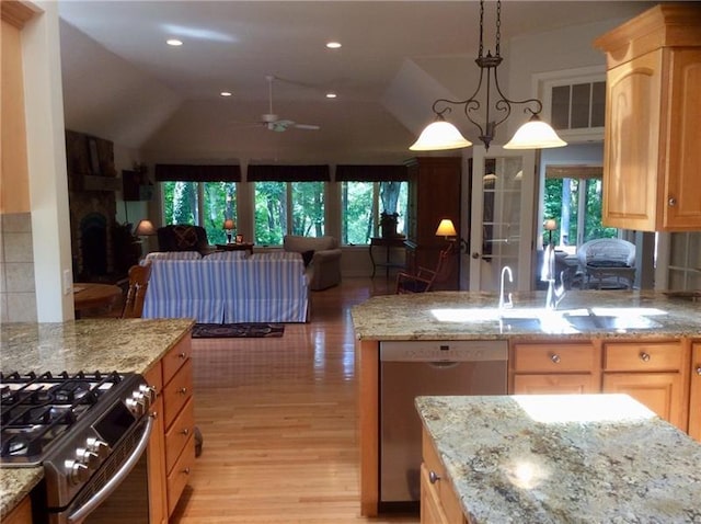 kitchen featuring light brown cabinetry, ceiling fan, hanging light fixtures, appliances with stainless steel finishes, and light hardwood / wood-style floors