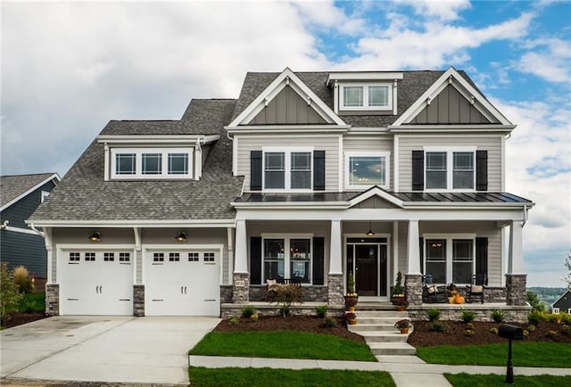 craftsman inspired home with a porch, a front lawn, and a garage