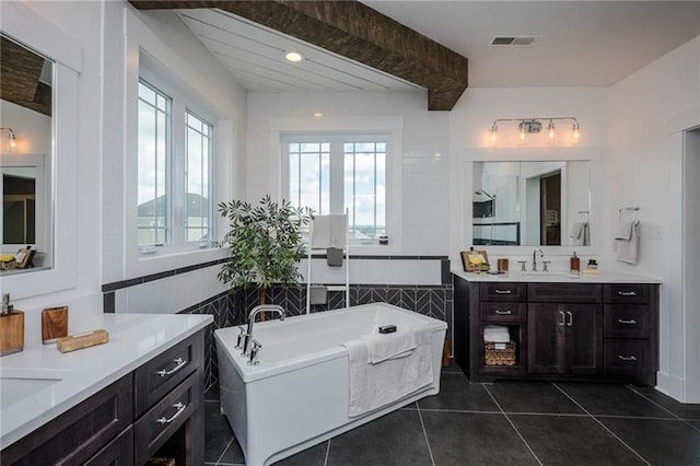 bathroom featuring a bath to relax in, tile flooring, and vanity