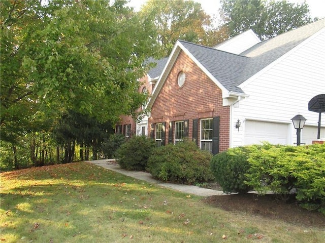 view of property exterior with a yard and a garage