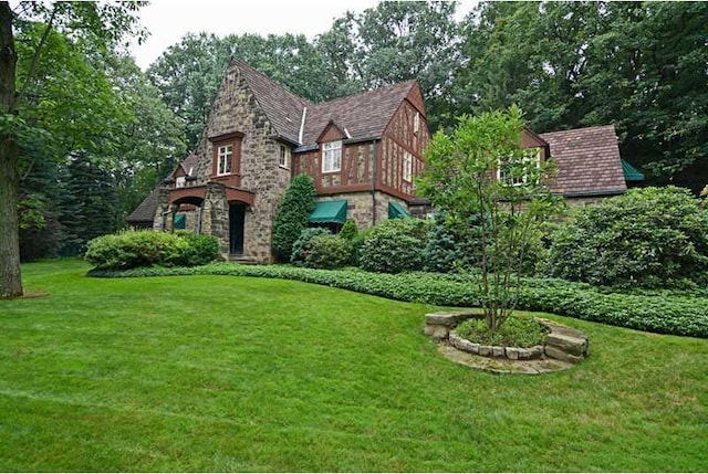 tudor home featuring a front yard