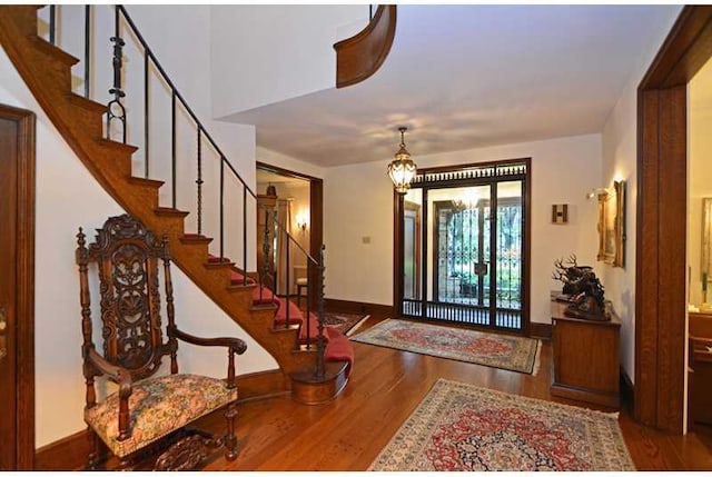 entryway featuring a notable chandelier and dark hardwood / wood-style flooring