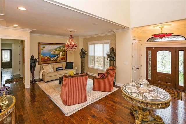 entryway with crown molding, dark wood-type flooring, and an inviting chandelier