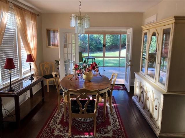 dining room with dark hardwood / wood-style floors and a chandelier