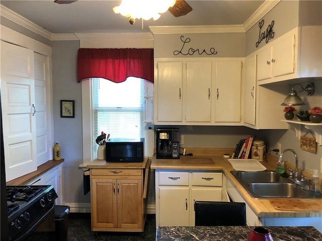 kitchen with ceiling fan, white cabinetry, crown molding, range, and sink