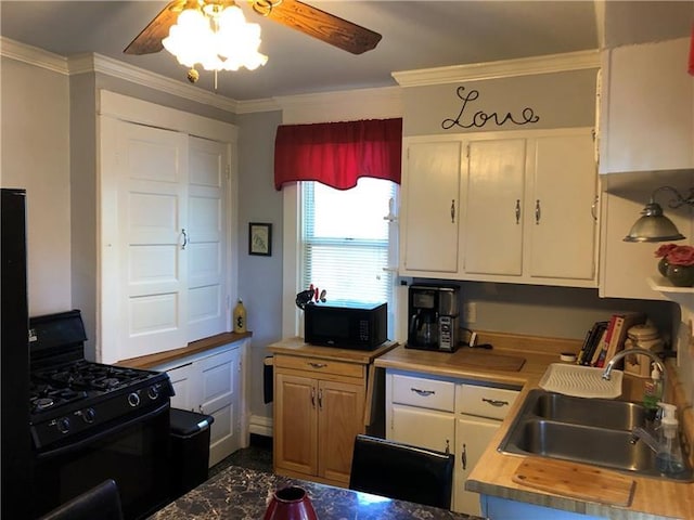 kitchen with white cabinets, sink, black appliances, ceiling fan, and ornamental molding