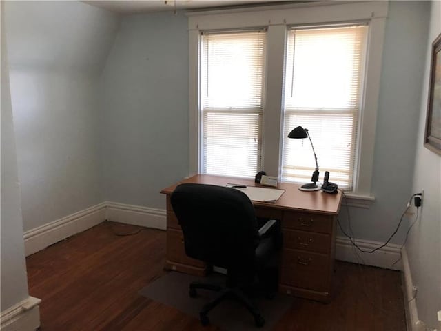 home office with lofted ceiling, dark wood-type flooring, and a wealth of natural light