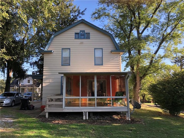 rear view of property with a yard