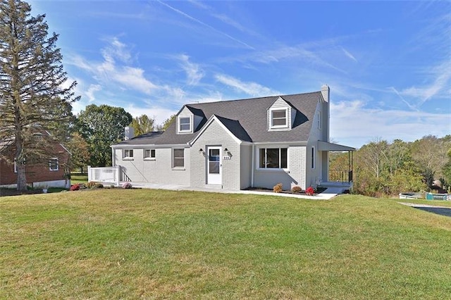 cape cod house with a front yard