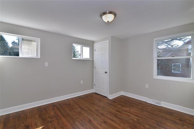 spare room with dark hardwood / wood-style flooring