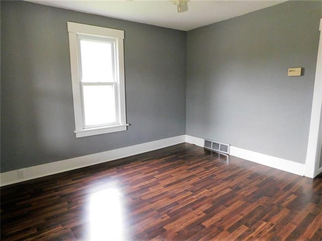 spare room with dark hardwood / wood-style flooring