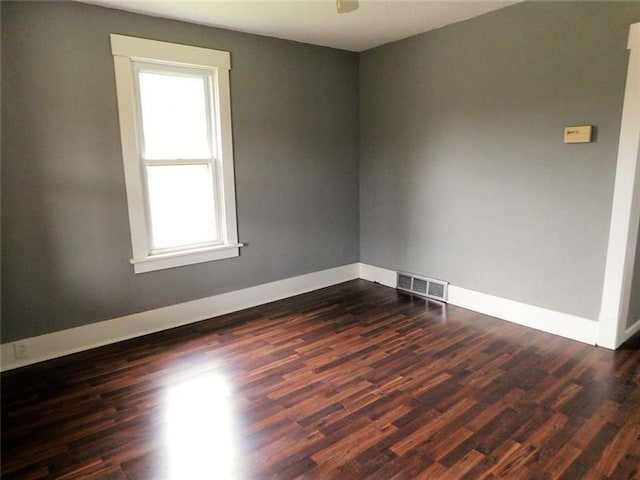 spare room featuring dark hardwood / wood-style floors