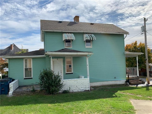 rear view of house with a yard