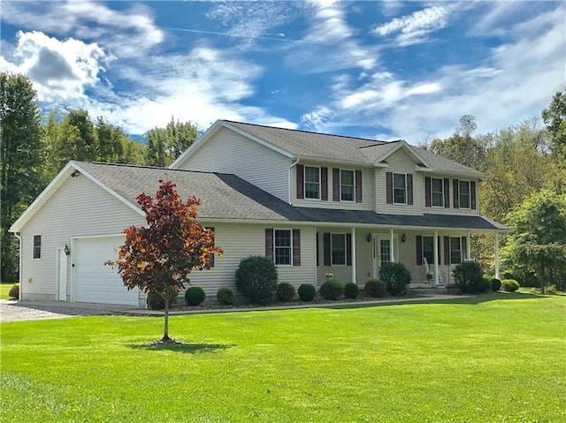 view of front of property with a front yard and a garage