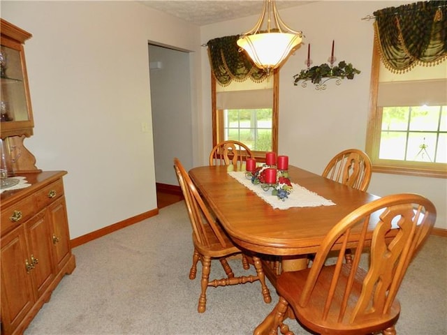 dining room featuring light colored carpet