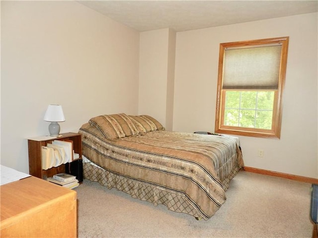 bedroom featuring light colored carpet