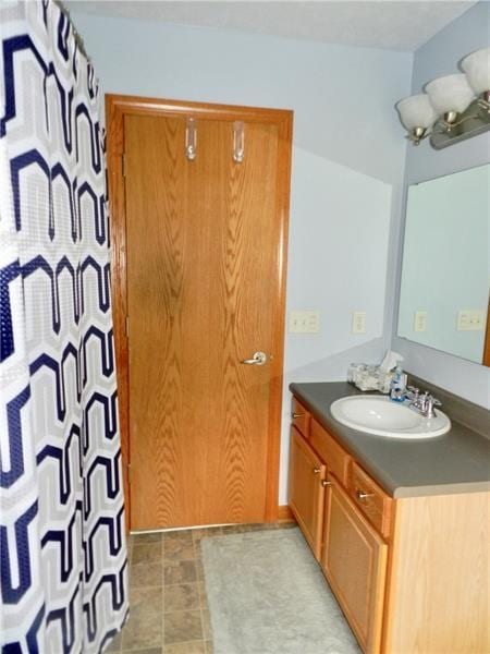 bathroom with tile floors and vanity with extensive cabinet space