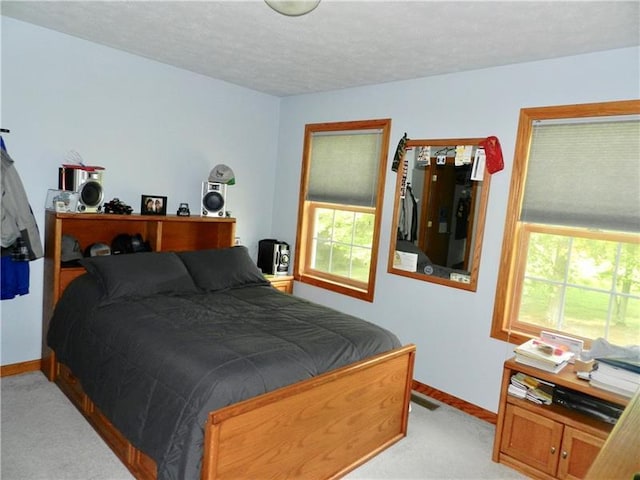 carpeted bedroom featuring a textured ceiling