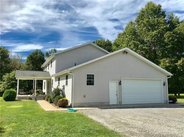 view of side of property featuring a lawn and a garage