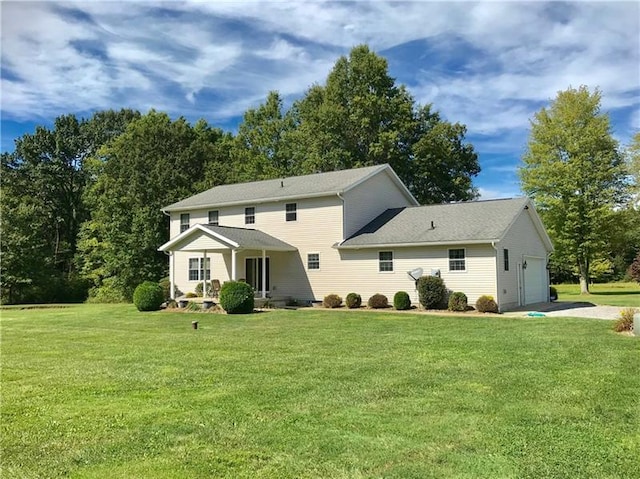 view of front of home with a porch, a front yard, and a garage