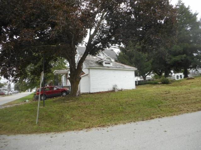 view of side of home featuring a yard