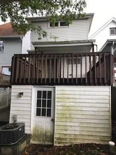 rear view of house featuring central air condition unit