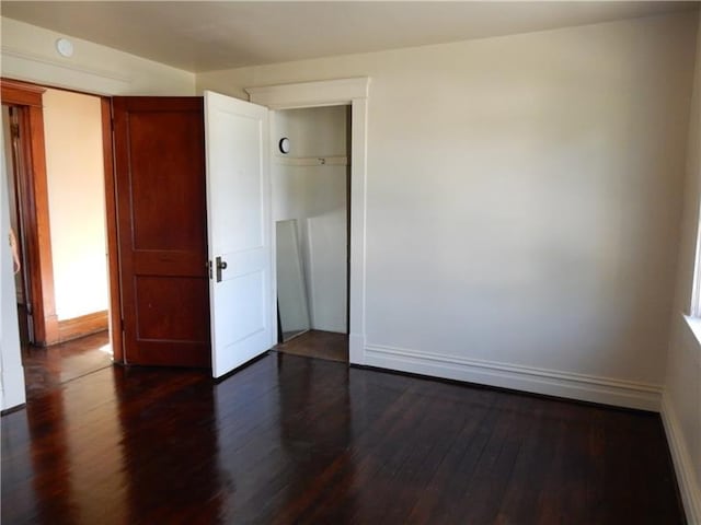 spare room featuring dark hardwood / wood-style floors