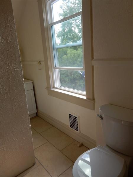 bathroom featuring toilet, tile floors, and vanity