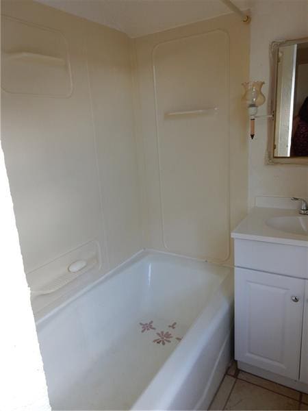 bathroom featuring shower / washtub combination, tile flooring, and vanity