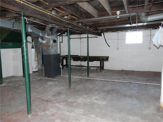 basement featuring heating utilities and water heater