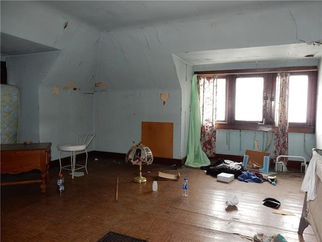 interior space featuring parquet flooring and vaulted ceiling