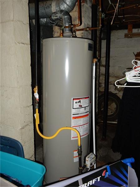 utility room featuring water heater