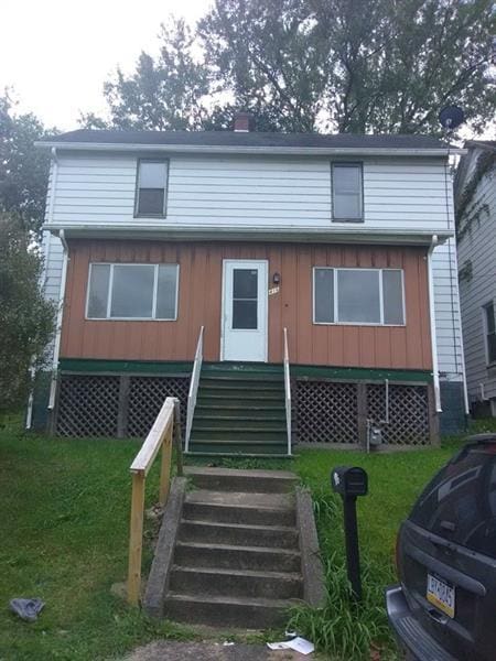 rear view of house with a yard