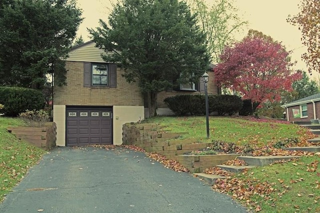 view of front of house with a garage and a yard