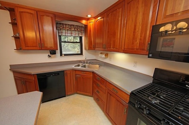 kitchen featuring light tile flooring, black appliances, and sink