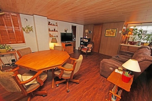 dining room with dark hardwood / wood-style flooring, wooden walls, and wood ceiling