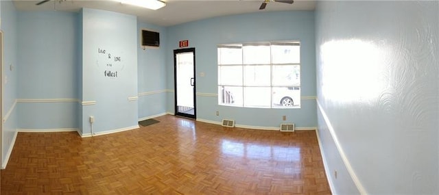 empty room featuring ceiling fan and dark parquet flooring