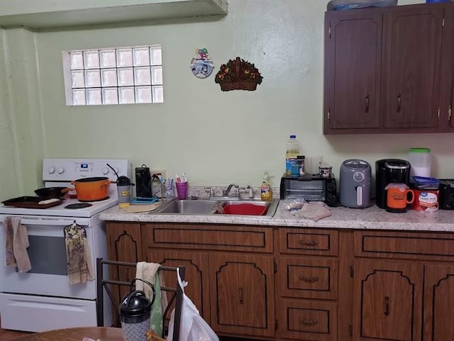 kitchen with white range with electric cooktop and sink