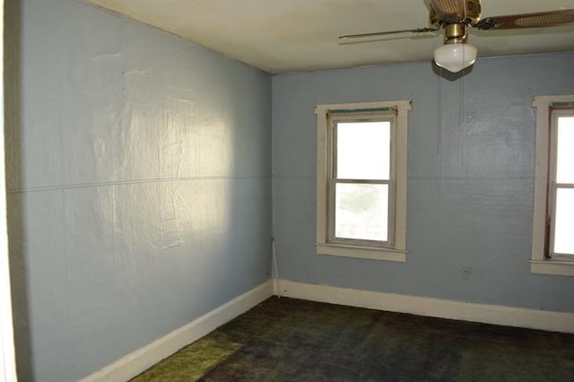 carpeted spare room with ceiling fan