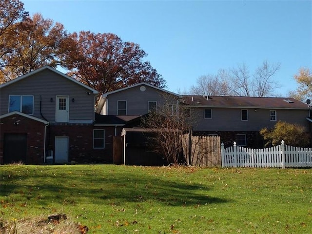 back of house with a lawn