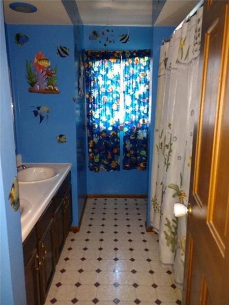 bathroom with vanity and tile floors