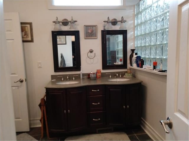 bathroom featuring double sink vanity and tile floors