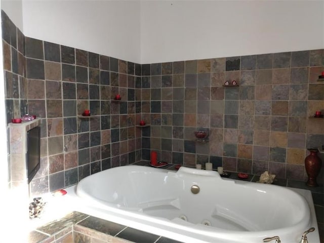 bathroom featuring a relaxing tiled bath